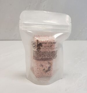 Pink shower steamer block scented with pepperberry, rose, and pepperment from Cleanse Gourmet