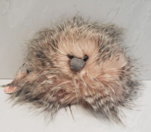 An 8" wide flamingo fluffy pouch from Jellycat