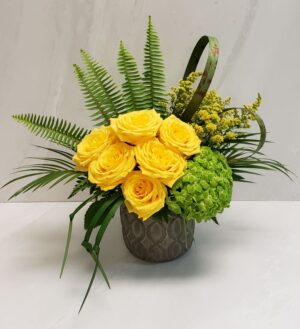 A bold arrangement of yellow roses and solidago accompanies with accents of greenery