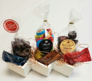 A white stone planter filled with an assortment of sweets