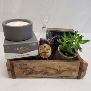 A selection of gifts for Him. Includes 3-wick candle, succulent, tech care kit, and sweets.