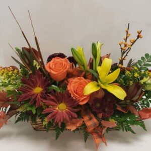 Beautiful, low autumn floral centerpiece arranged in a basket