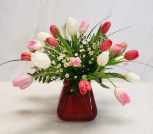 A sweet arrangement of pink, red, and white tulips.