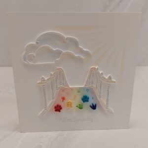 6x6 quilling card of a rainbow bridge that says, "With Sympathy" below.